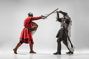 Image showing Brave armored knights fighting isolated on white studio background