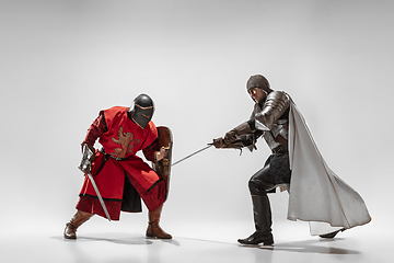 Image showing Brave armored knights fighting isolated on white studio background