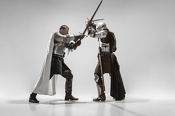 Image showing Brave armored knights fighting isolated on white studio background