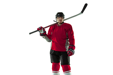 Image showing Male hockey player with the stick on ice court and white background