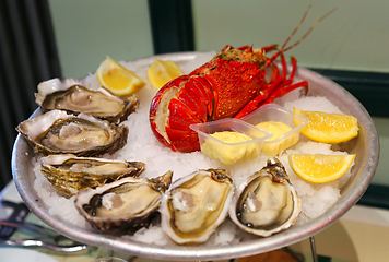 Image showing Large dish with fresh seafood, oysters with lobster with lemon a