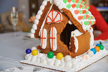 Image showing Broken Gingerbread house on the table in Christmas decorated roo