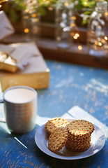 Image showing Teacup and Christmas gluten free cookies on a table near the dec