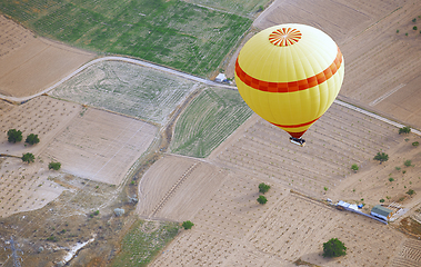 Image showing Air balloon flying over the land