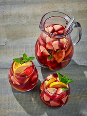 Image showing red sangria on wooden table