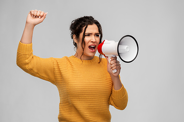 Image showing angry young woman speaking to megaphone