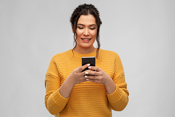 Image showing happy woman using smartphone