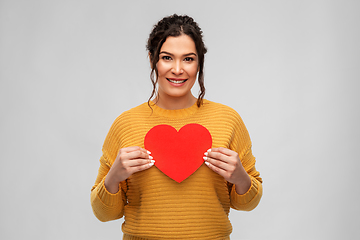 Image showing happy smiling young woman with red heart