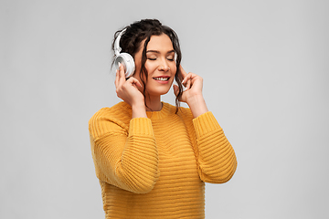 Image showing happy woman in headphones listening to music