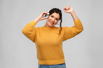 Image showing happy woman in headphones listening to music