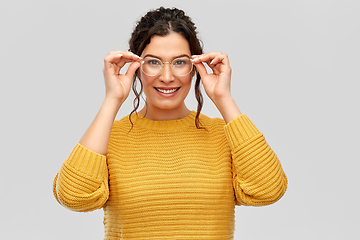 Image showing happy smiling young woman in glasses