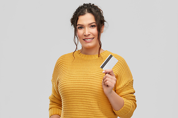 Image showing happy smiling young woman with credit card