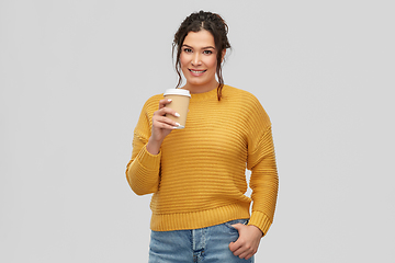 Image showing smiling woman with pierced nose holding coffee cup