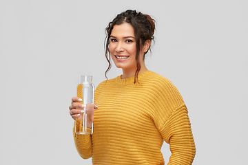 Image showing smiling young woman with water in glass bottle