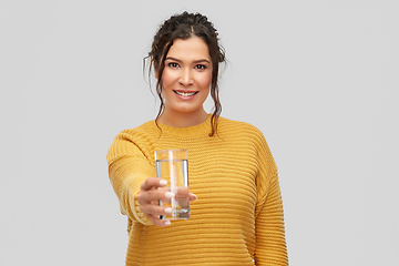 Image showing smiling young woman with water in glass