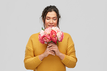 Image showing happy smiling young woman with bunch of flowers