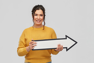 Image showing smiling young woman with big white right arrow