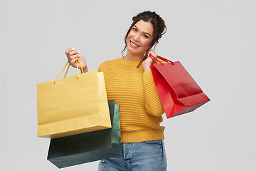 Image showing happy smiling young woman with shopping bags