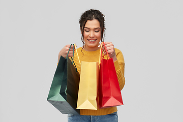 Image showing happy smiling young woman with shopping bags