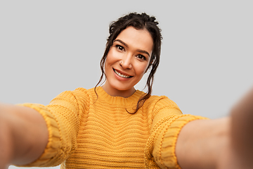 Image showing smiling woman with pierced nose taking selfie