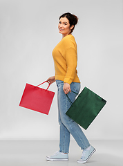 Image showing happy smiling young woman with shopping bags