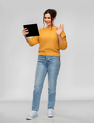Image showing happy young woman having video call on tablet pc