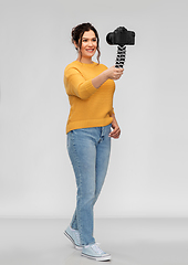 Image showing smiling woman blogger with camera recording video