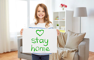 Image showing happy girl holding stay home message on paper