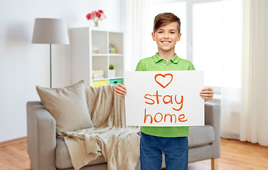 Image showing happy boy holding stay home message on paper