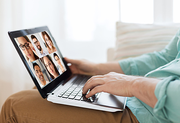 Image showing man with laptop having video call with colleagues