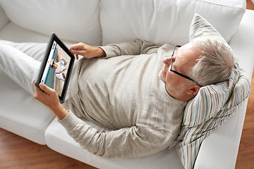 Image showing old man with tablet pc has video call with woman