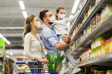 Image showing family with shopping cart in masks at supermarket