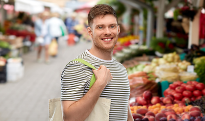 Image showing man with reusable shopping bag at street market