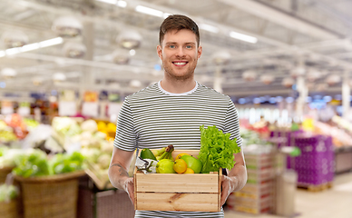 Image showing happy smiling man with food in wooden box