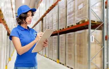 Image showing delivery girl with clipboard at warehouse