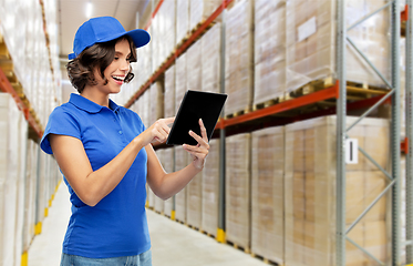 Image showing happy delivery girl with tablet pc at warehouse