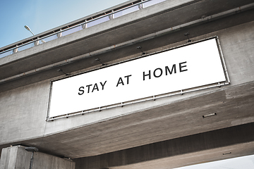 Image showing billboard with stay at home words on bridge