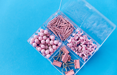 Image showing pins and clips in plastic pox on blue background