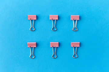 Image showing office binder clips on blue background