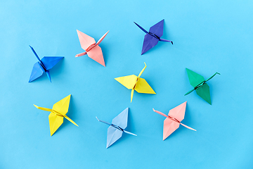 Image showing origami paper cranes on blue background
