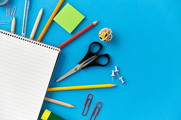 Image showing notebook and school supplies on blue background