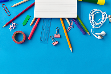 Image showing notebook and school supplies on blue background