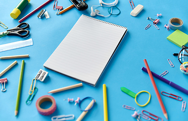 Image showing notebook and school supplies on blue background