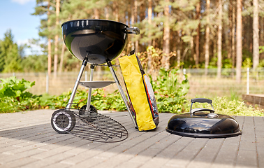 Image showing bbq grill brazier and bag of charcoal outdoors