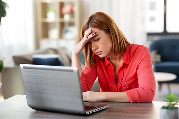 Image showing stressed woman with laptop working at home office