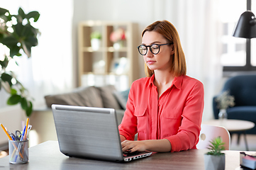 Image showing woman with laptop working at home office