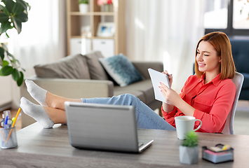 Image showing woman with notebook and laptop at home office