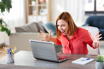 Image showing angry woman with laptop working at home office