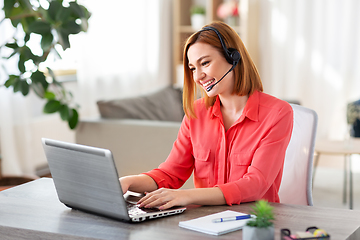 Image showing woman with headset and laptop working at home