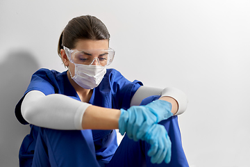 Image showing sad doctor or nurse in goggles and face mask